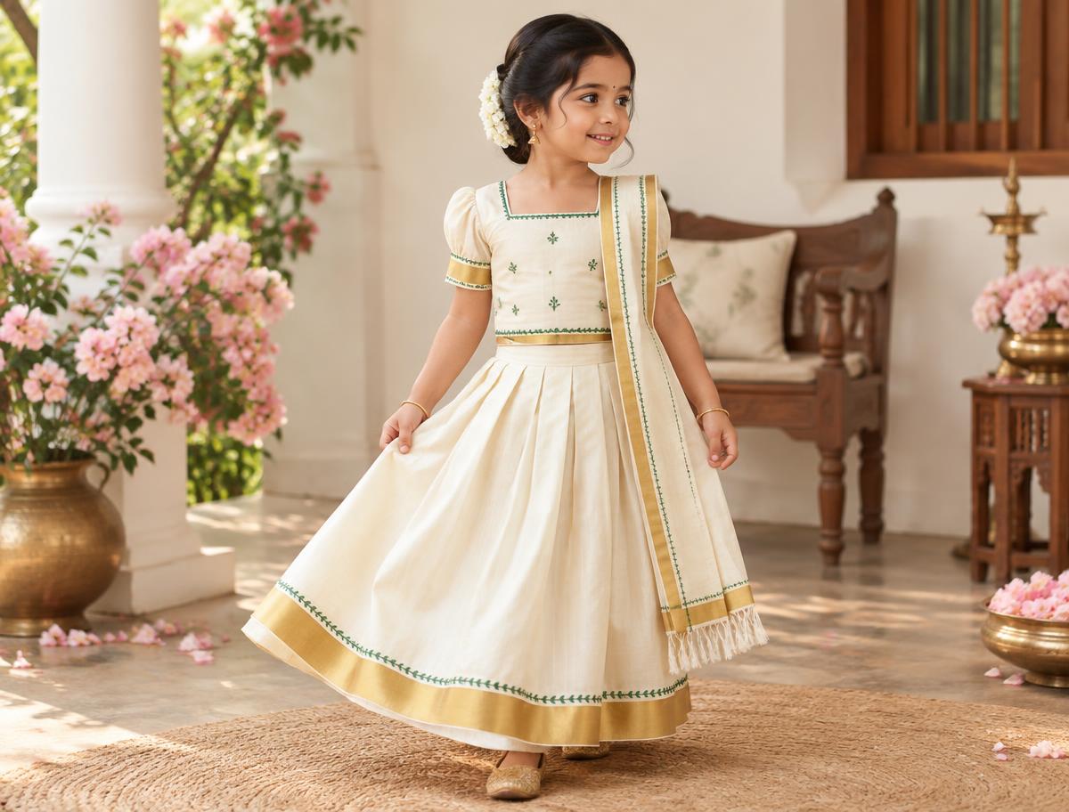 A child in a carefully fitted Kerala traditional outfit